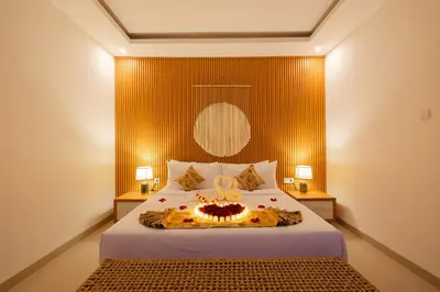 a bedroom with a bed with a cake on it at Arvi Villa Pandawa Legian in Legian