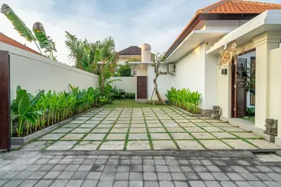 a courtyard of a house with a driveway at Alicia - Stylish 2BR Villa with Large Pool in Kerobokan
