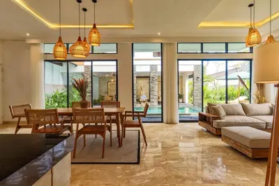 a living room with a table and a couch at Villa Club Residence 8 by Maheswara in Canggu