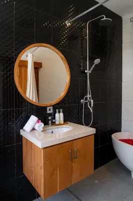 a bathroom with a sink and a shower and a mirror at Villa Grace a 2BR Retreat with private pool in Seminyak