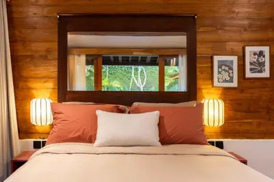 a bedroom with a bed with a mirror above it at Villa Camini - Newly Renovated Beautiful 2BR Family Villa 6px With Garden And Private Pool in Kerobokan