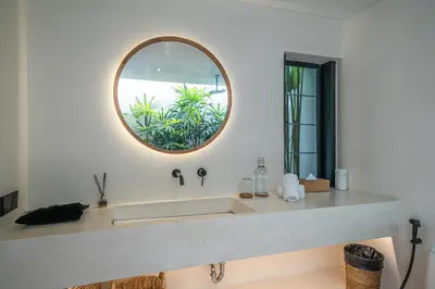 a bathroom with a sink and a mirror at Villa Luuma 3 - Cozy Umalas Oasis, 1BR Private Villa in Canggu