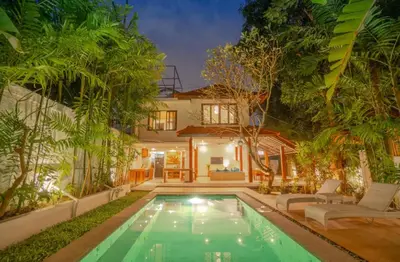 a swimming pool in front of a house at The Padma Room in Kerobokan