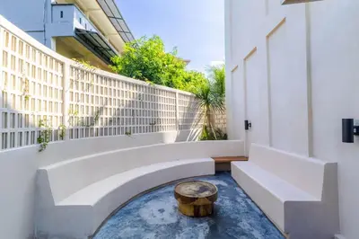 a courtyard with a tree stump in the middle of a building at Villa San Miguel by Pertama Management in Seminyak