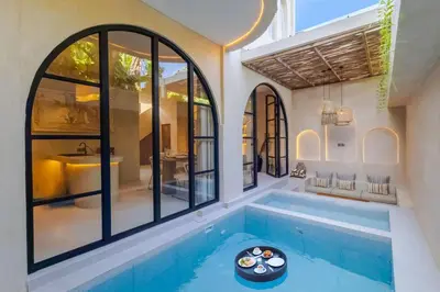 a swimming pool in a house with a tub at Villa Santa Clara by Pertama Management in Seminyak