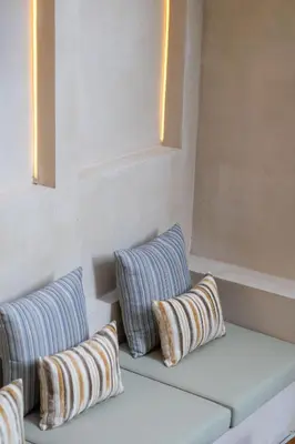 two pillows sitting on a couch in a room at Villa Santa Clara by Pertama Management in Seminyak