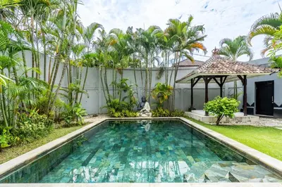 a swimming pool in the backyard of a villa at The Hijau Damai Villa in Seminyak