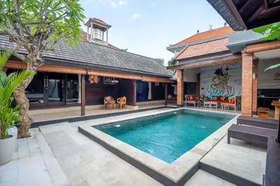 a swimming pool in the backyard of a house at Villa jepun berawa in Canggu