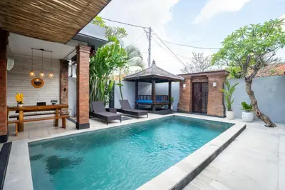 a swimming pool in the backyard of a house at Villa jepun berawa in Canggu