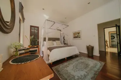 a bedroom with a bed with a canopy at Villa Delapan Seminyak in Seminyak