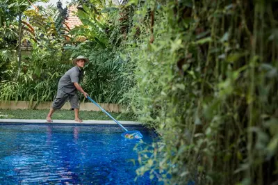 a young boy paddling a paddle in a pool at Villa Delapan Seminyak in Seminyak