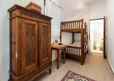 a room with a large wooden cabinet and a bunk bed at Villa Delapan Seminyak in Seminyak