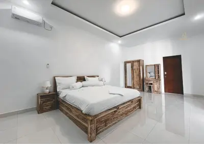 a bedroom with a large bed in a white room at Mika Estate Property in Seminyak