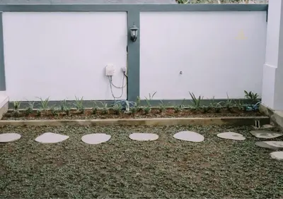 a group of stepping stones in front of a building at Mika Estate Property in Seminyak