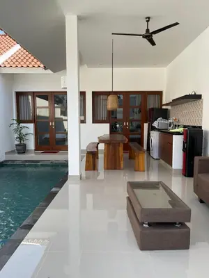 a living room and kitchen with a swimming pool at Villa Cassia Jimbaran in Jimbaran