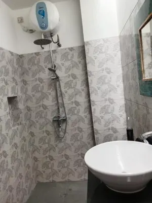 a bathroom with a shower and a white sink at Villa Cassia Jimbaran in Jimbaran