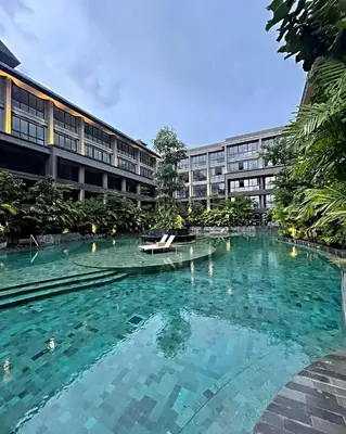 a large swimming pool in front of a building at MODERN 2 BEDROOM LAVAYA OAKWOOD APARTMENT, Nusa Dua in Nusa Dua