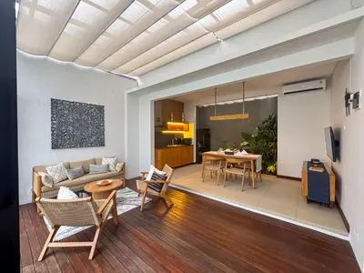 a living room with a couch and a table at Silk Umalas by Nagisa Bali in Kerobokan