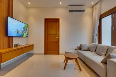 a living room with a couch and a flat screen tv at New! Villa Taman Seminyak 01 near Double Six Beach in Seminyak