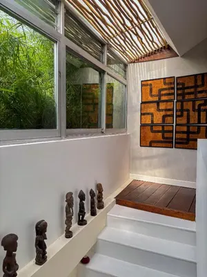 a staircase in a house with a window at Tropical Townhouse 3 Bedrooms Seminyak in Seminyak