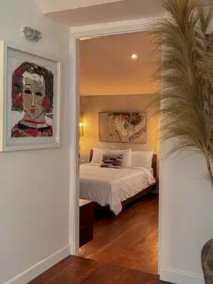 a bedroom with a bed and a large mirror at Tropical Townhouse 3 Bedrooms Seminyak in Seminyak