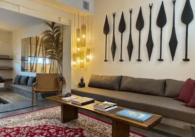 a living room with a couch and a table at Tropical Townhouse 3 Bedrooms Seminyak in Seminyak