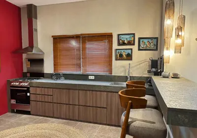 a kitchen with a counter and a sink and a stove at Tropical Townhouse 3 Bedrooms Seminyak in Seminyak