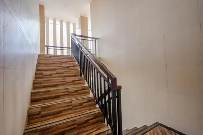 a staircase in a building with wooden floors at Homely Bali at Seminyak in Kerobokan