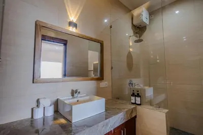 a bathroom with a sink and a mirror at Homely Bali at Seminyak in Kerobokan
