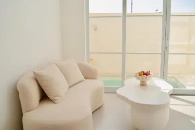 a living room with a white couch and a table at Villa Azura in Perean