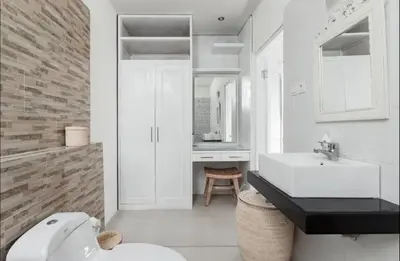 a white bathroom with a sink and a toilet at Walk to Beach - Private 3 Bedroom Villa Roshi Seminyak in Seminyak