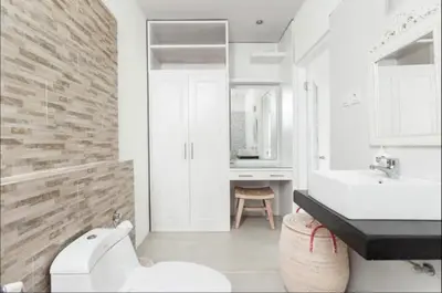 a white bathroom with a sink and a toilet at Walk to Beach - Private 3 Bedroom Villa Roshi Seminyak in Seminyak
