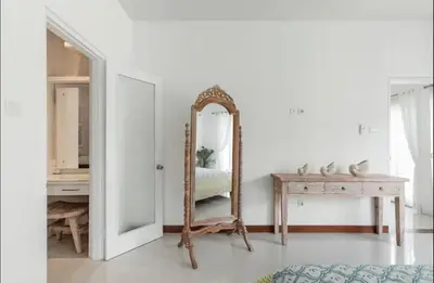 a white room with a mirror and a table at Walk to Beach - Private 3 Bedroom Villa Roshi Seminyak in Seminyak