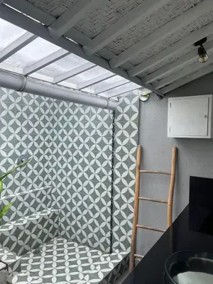 a room with a wall with a table and a chair at Villa Louise in Badung