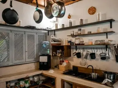 a kitchen with pots and pans hanging above a counter at My secret home ( full villa) in Seminyak
