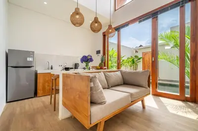 a living room with a couch and a kitchen at A26 - Private Pool Villa in Seminyak in Seminyak