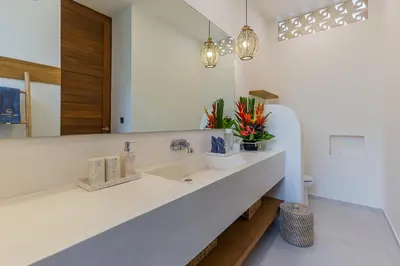 a bathroom with a sink and a mirror at Villa Trindade 5BR, 15m Pool in Seminyak