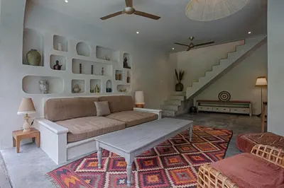 a living room with a couch and a staircase at Villa Inde Noi - Beautiful stylish bohemian 2bdrs villa - Kerobokan in Kerobokan