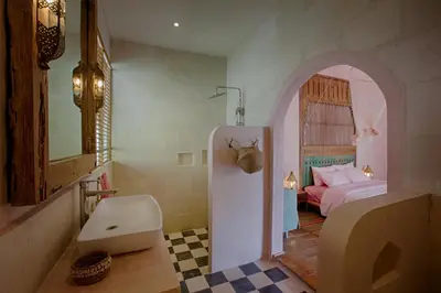 a bathroom with a sink and a bed in a room at Villa Inde Noi - Beautiful stylish bohemian 2bdrs villa - Kerobokan in Kerobokan