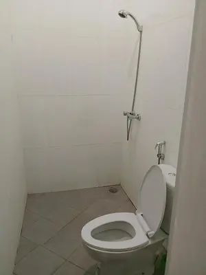 a small bathroom with a toilet and a shower at Terace Campus A4 in Jimbaran