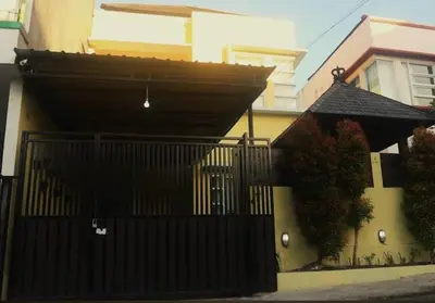 a black gate in front of a house at Terace Campus A4 in Jimbaran