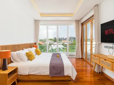 a bedroom with a large bed and a large window at Lux 500sqm 5BR Villa, 400m to FINNS & Canggu Beach in Canggu