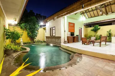 a swimming pool in the middle of a house at Putri Bali Seminyak Villa in Seminyak
