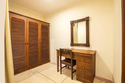 a bathroom with a wooden desk and a mirror at Putri Bali Seminyak Villa in Seminyak