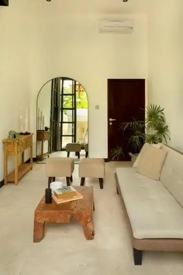 a living room with a couch and a table at Balidroomvilla Sanur Mangrove - Full Serviced - Beachside in Sanur
