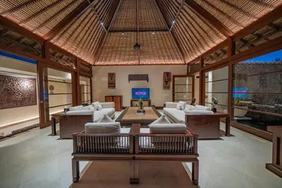 a living room with white couches and a table at Villa Wibisana Beachside Luxury in Seminyak in Seminyak