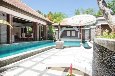 an external view of a villa with a swimming pool at Beachside Villa Di Bucu in Canggu