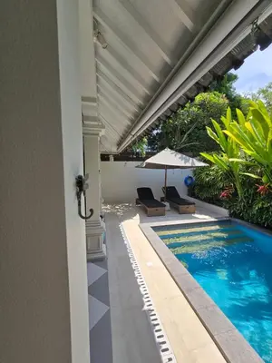 an external view of a swimming pool in a house at Villa Seni in Seminyak