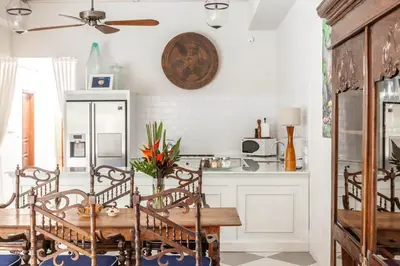 a kitchen with a wooden table and chairs at Villa Seni in Seminyak