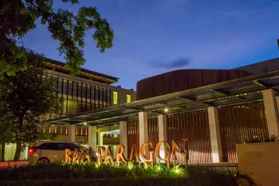 a building with a sign in front of it at night at Bali Paragon Resort Hotel in Jimbaran